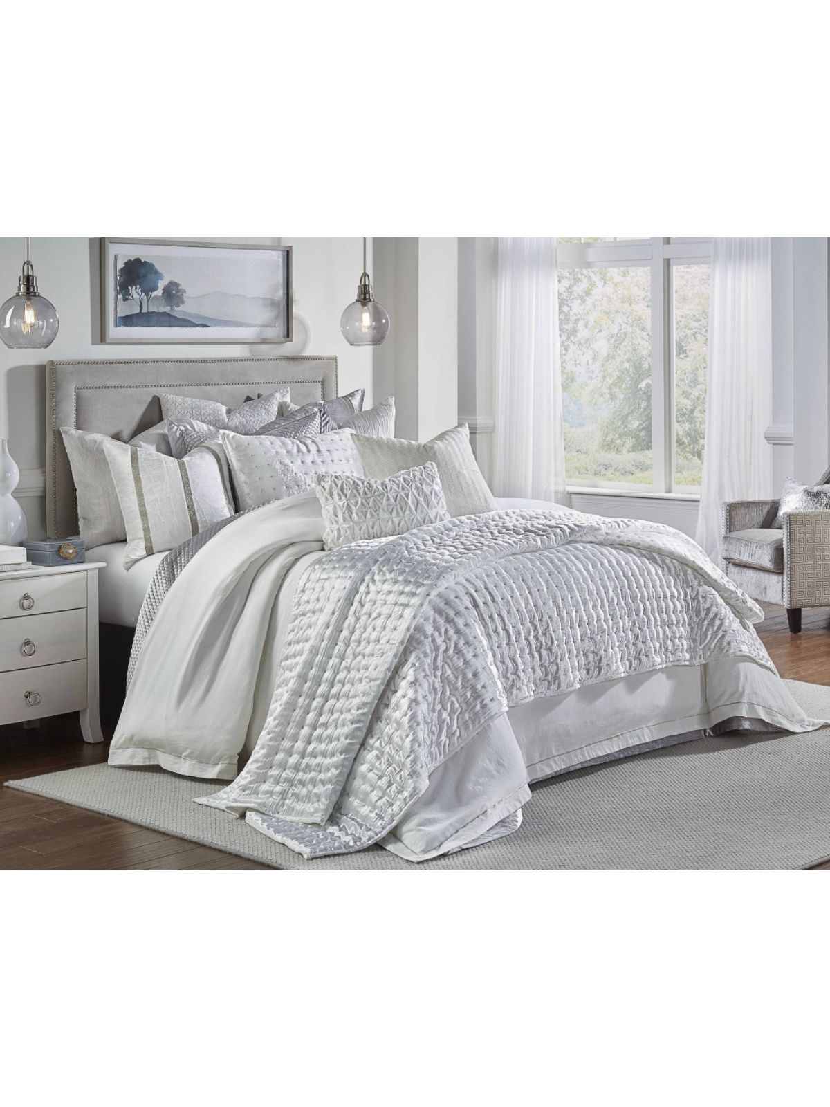 Ivory king quilt set with metallic dots and reversible shams on a neatly made bed.