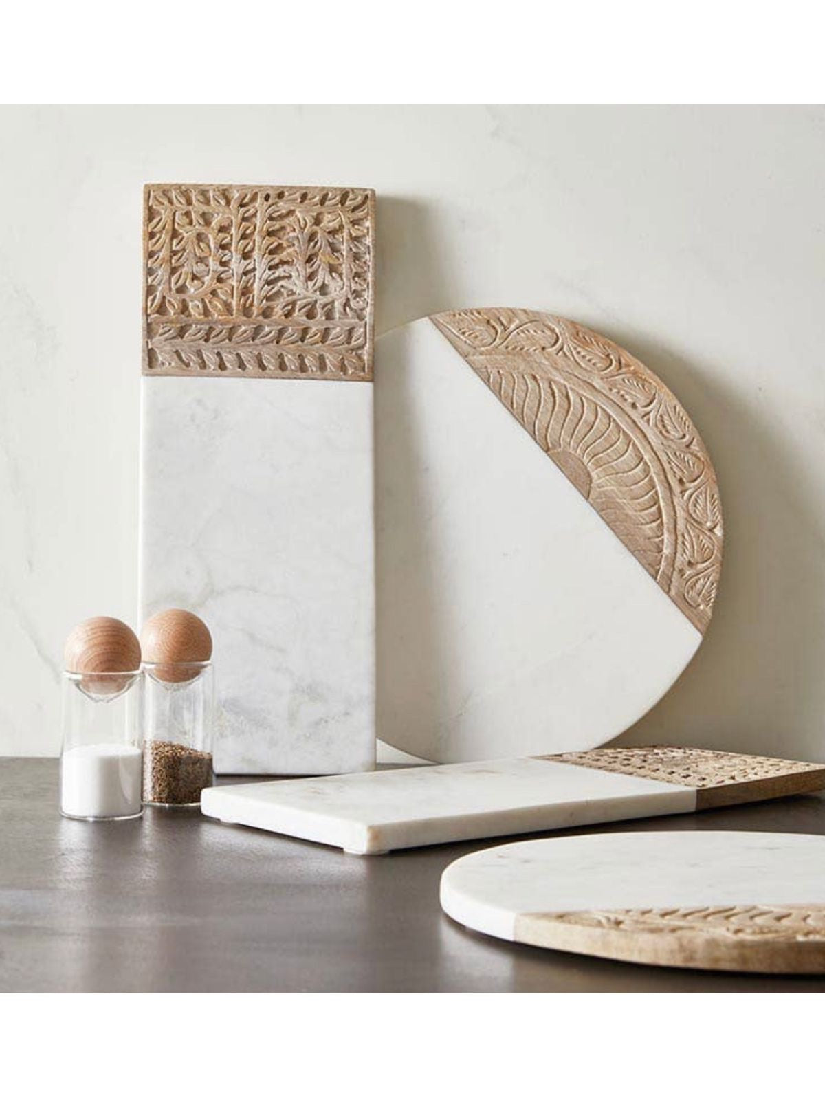 This gorgeous unique 12in round board is mixed with white marble and natural mango wood. Use this board to display appetizers, cheeses and charcuterie available at KYA Home Decor