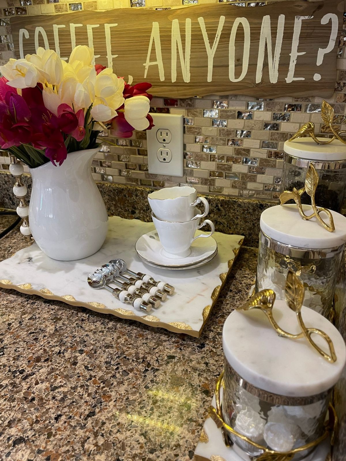 Set of 4 Stainless Steel Dessert Spoons with Gold and White Pearl Designed Handles on coffee display.