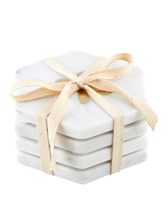 Add a loving touch to your home with our White Marble XOXO Coaster Set. This set includes 4 white marble coasters in the shape of hexagons, 2 with an X and 2 with an O at the center. Available at KYA Home Decor
