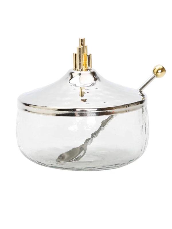 This honey dish features a lustrous stainless steel finish and finely lined gold symmetrical design. Measures 4.3 D and Includes spoon and lid. Sold by KYA Home Decor