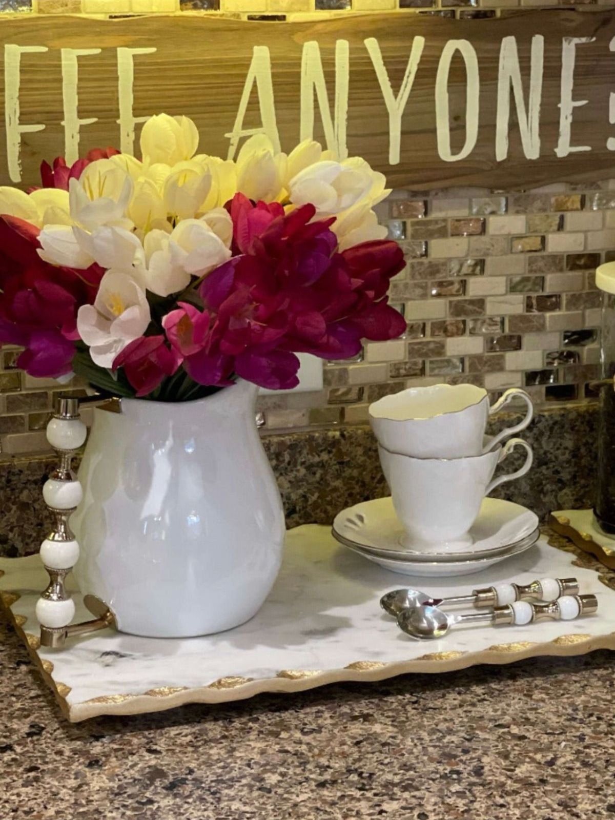 White Ceramic Pitcher with White and Gold Beaded Handle With Floral Arrangements.