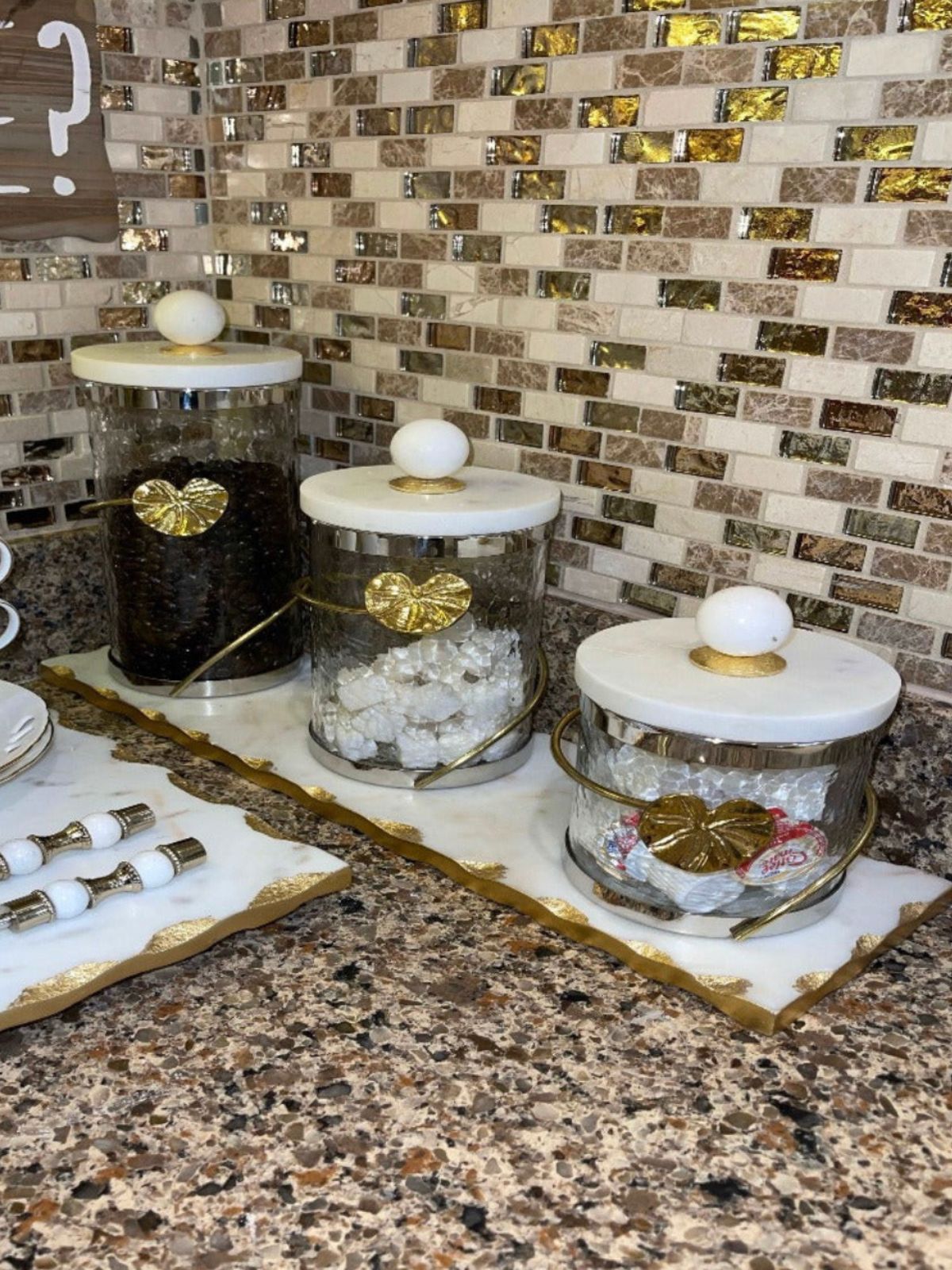 These Glass Canister with Gold Metal Heart Design and Marble Lid are available in 3 sizes and Sold by KYA Home Decor