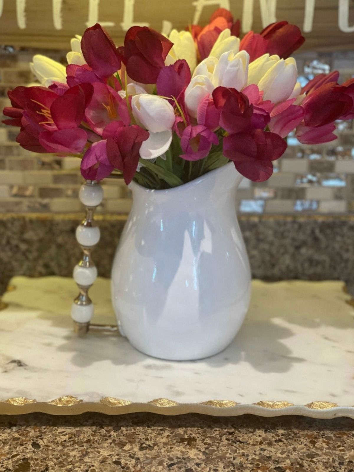 White Ceramic Pitcher with White and Gold Beaded Handle With Pink Floral Arrangements.