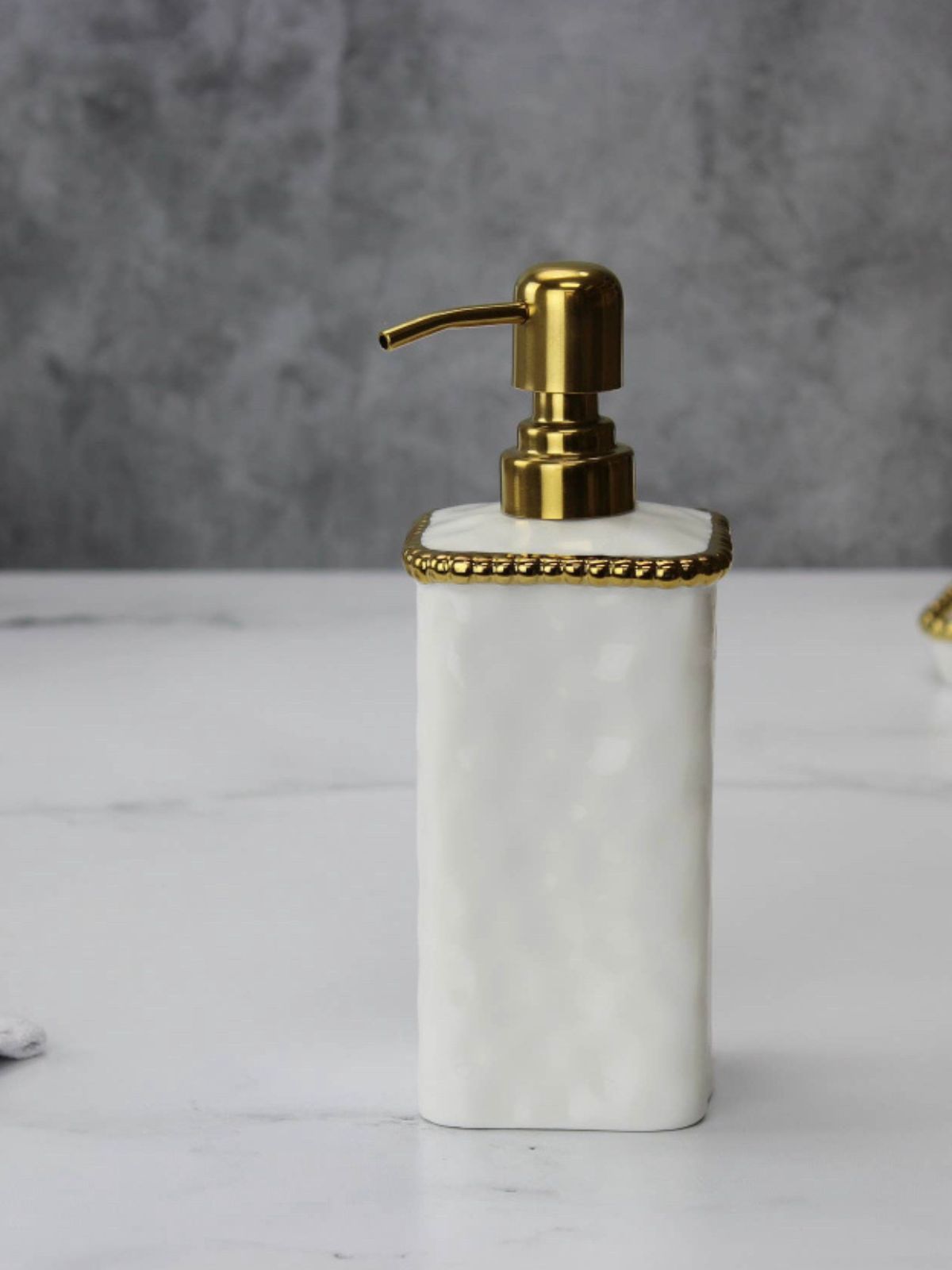 Elevate the look of your vanity with this elegant soap dispenser. Made from hight quality and High- fired porcelain with gold titanium beading. Both practical and charming, bring elegance into your house!