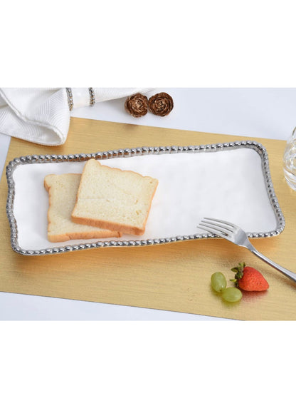 Rectangular Porcelain Serving Tray with Silver Beaded Edges Sold by KYA Home Decor.