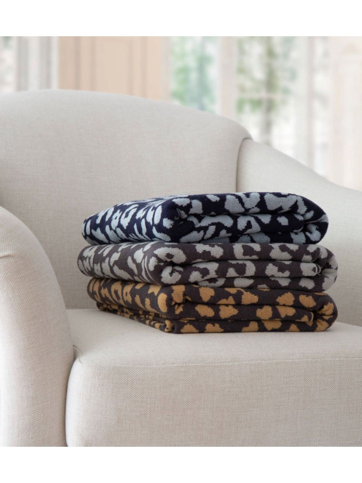 100% cotton leopard design throw blanket with lush hand feel fully reversible and yarn-dyed for lasting rich color. Available in 3 colors.