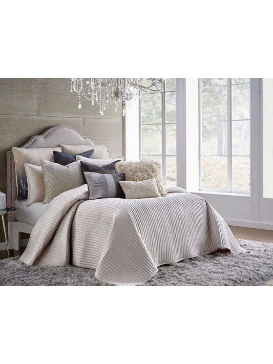The Maya beige velvet quilt has a dominant silvery metal layer. The shiny silver will pair well in any toned down area.