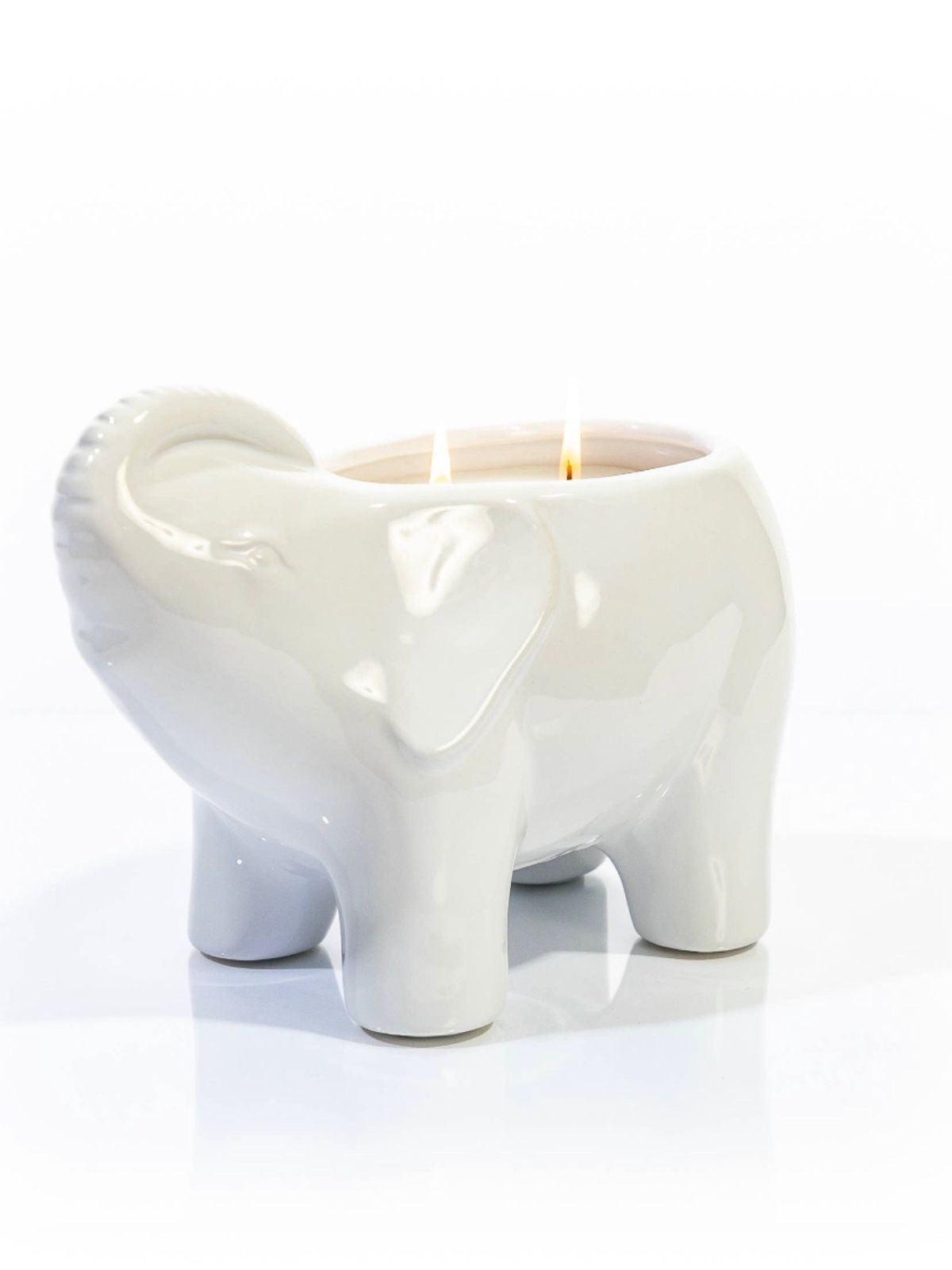 This elegant white elephant candle is designed and finished by hand sculpting the ceramic of each vessel. These candles are then hand filled with a proprietary soy wax blend, all natural essential oils, and 2 cotton wicks to provide a clean burn.  