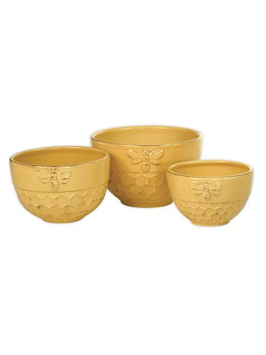Add a playful pop of color to your kitchen with Honeycomb Nesting Bowls. Crafted in ceramic, each dark yellow piece is deeply embossed with a honeycomb pattern and a bee. 