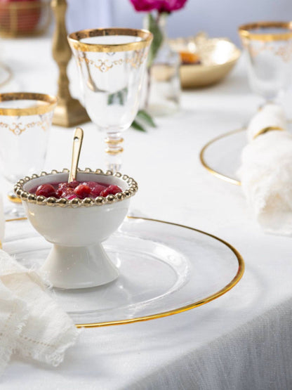 Situated on a stand, these gold edged dessert bowls elegantly close a meal. Its pure white color makes it the ideal dish to fill with colored berries and melons for a charming Completion of Feast.