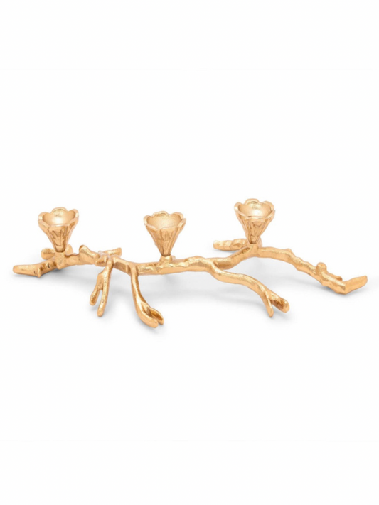 This brass gold tea light candle holder has a gold branch design and holds three tapered candles.