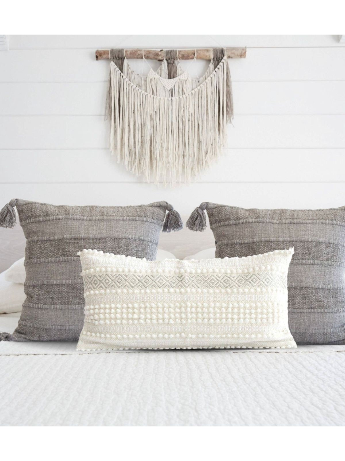 This 100% Cotton Wide Striped Pillow Cover with pom pom tassels measures 18x18 has a soft linen texture that will add a boho yet modern touch to any space. Available in 2 colors, Sold by KYA Home Decor    