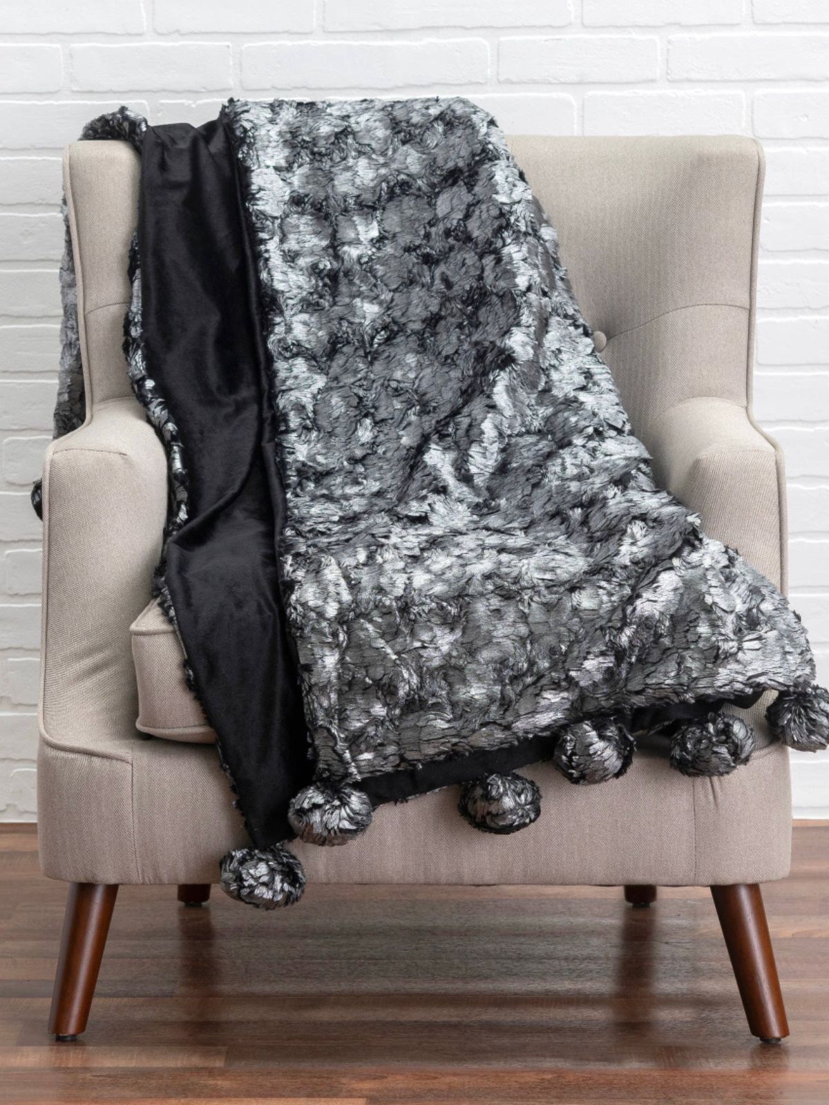 The Sable throw is a luxurious feather like faux fur with a silver metallic look, 50W x 60L. 