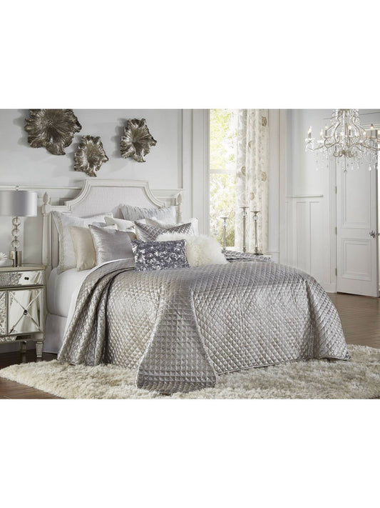 The silver Aura quilt features a woven fabric with a metallic chevron pattern which is quilted in a diamond box pattern. This shimmery quilt will add glitz and glamor to any room.