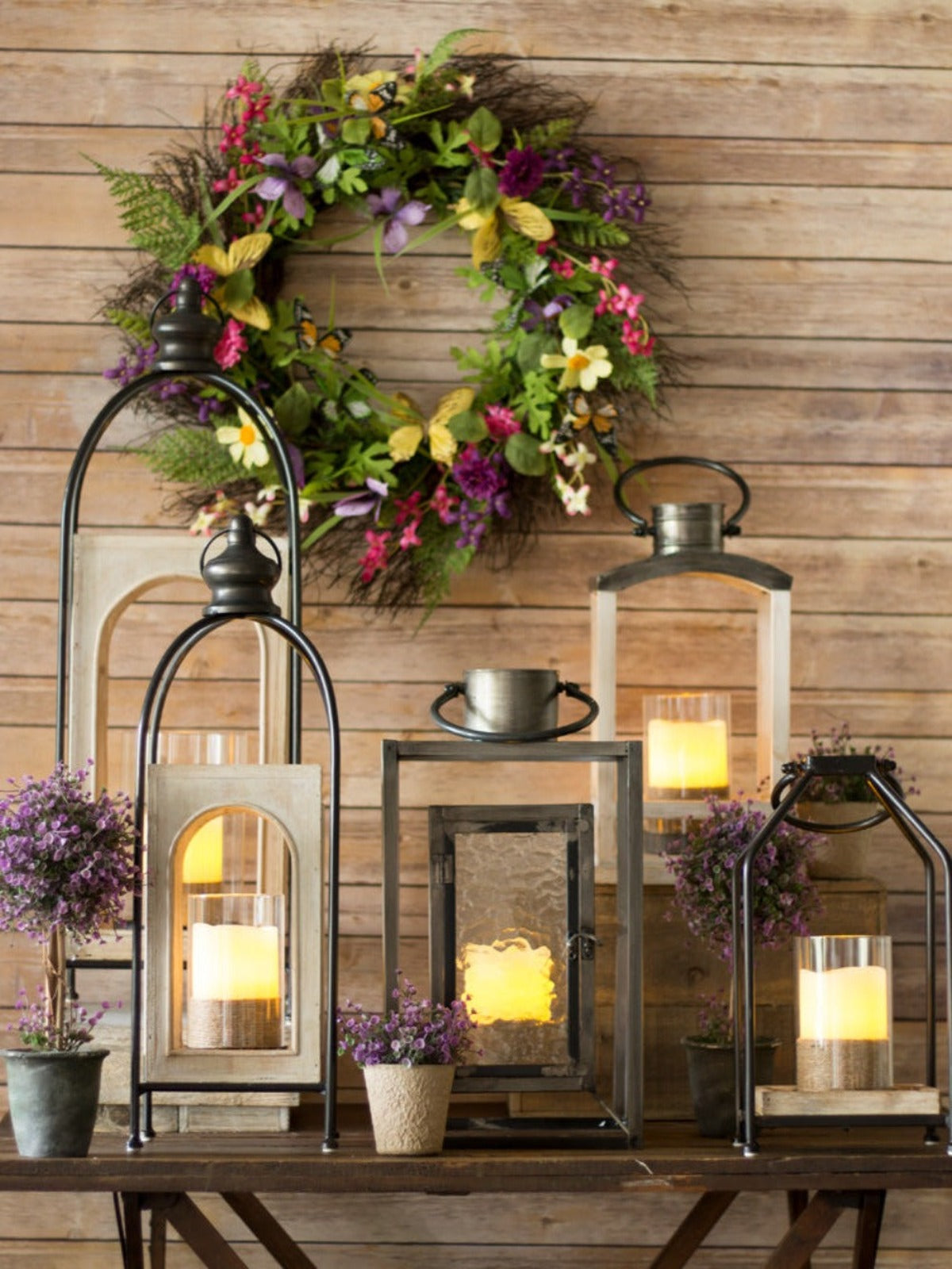 The modern country style of the Cambridge Lantern offers an impressive way to give your space a warm glow. A wooden case holds a glass hurricane within an open metal frame. 