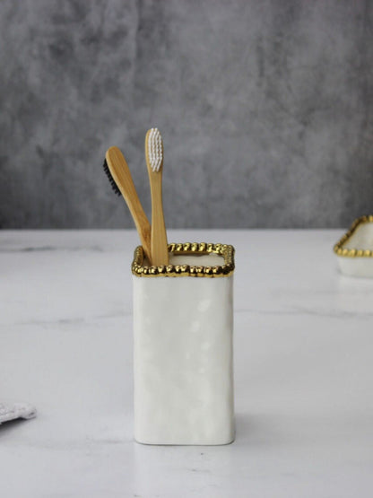 White Porcelain Toothbrush Holder with Gold Beaded Edges Sold by KYA Home Decor.