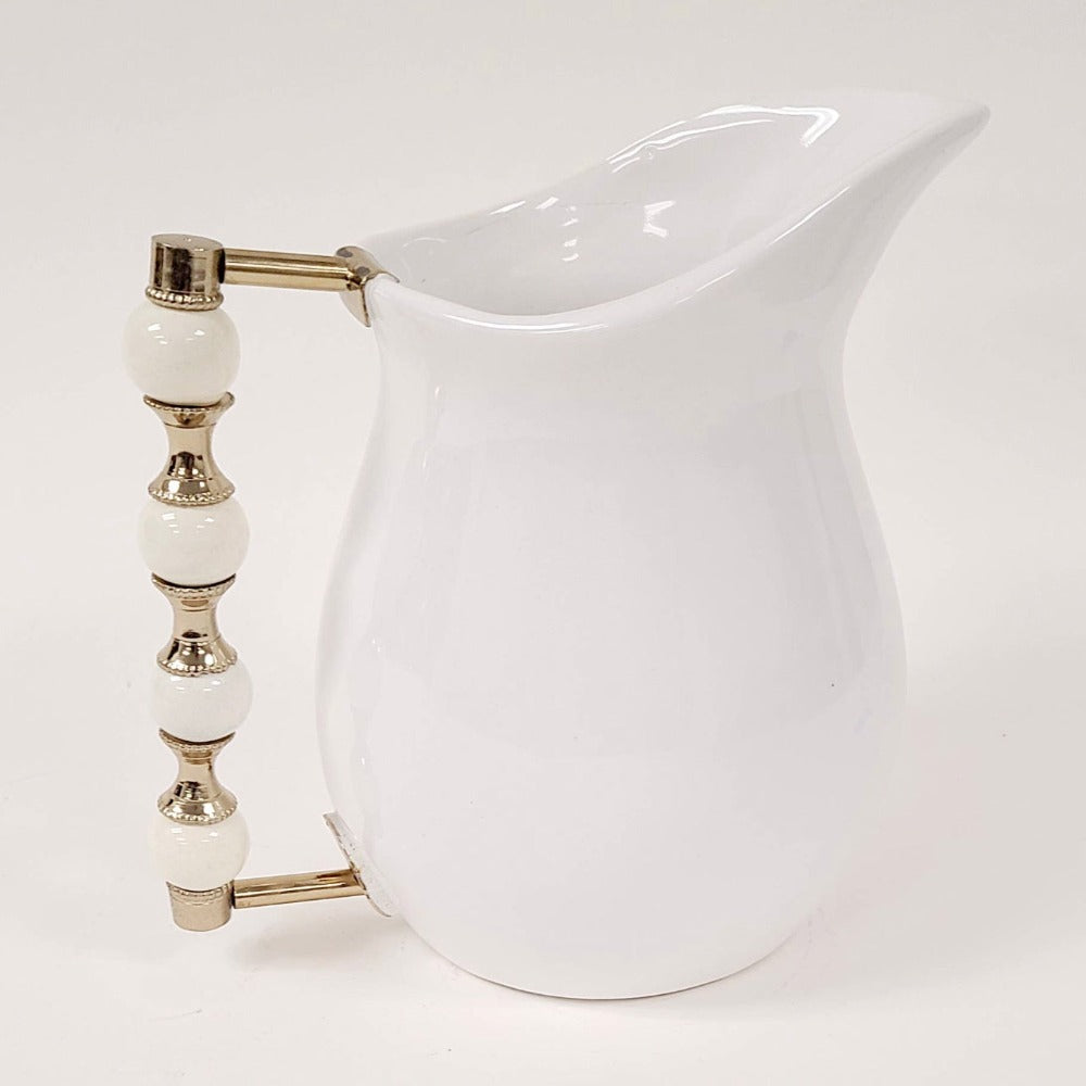 The Perline White Pitcher features a beaded handle that is oh so stunning. Use it to serve your favorite beverage or to style a beautiful floral arrangement.
