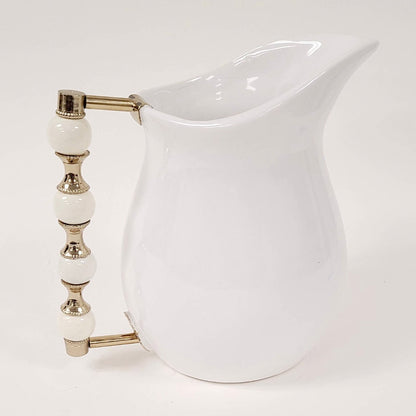 The Perline White Pitcher features a beaded handle that is oh so stunning. Use it to serve your favorite beverage or to style a beautiful floral arrangement.