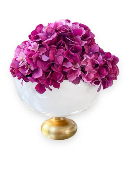 White Glass Footed Bowl on Lustrous Gold Base Staged with Pink Flowers.
